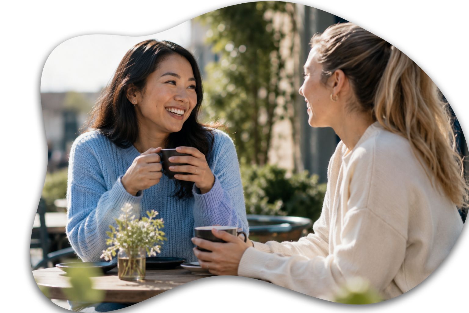 Image: Two close friends enjoying coffee outdoors while talking