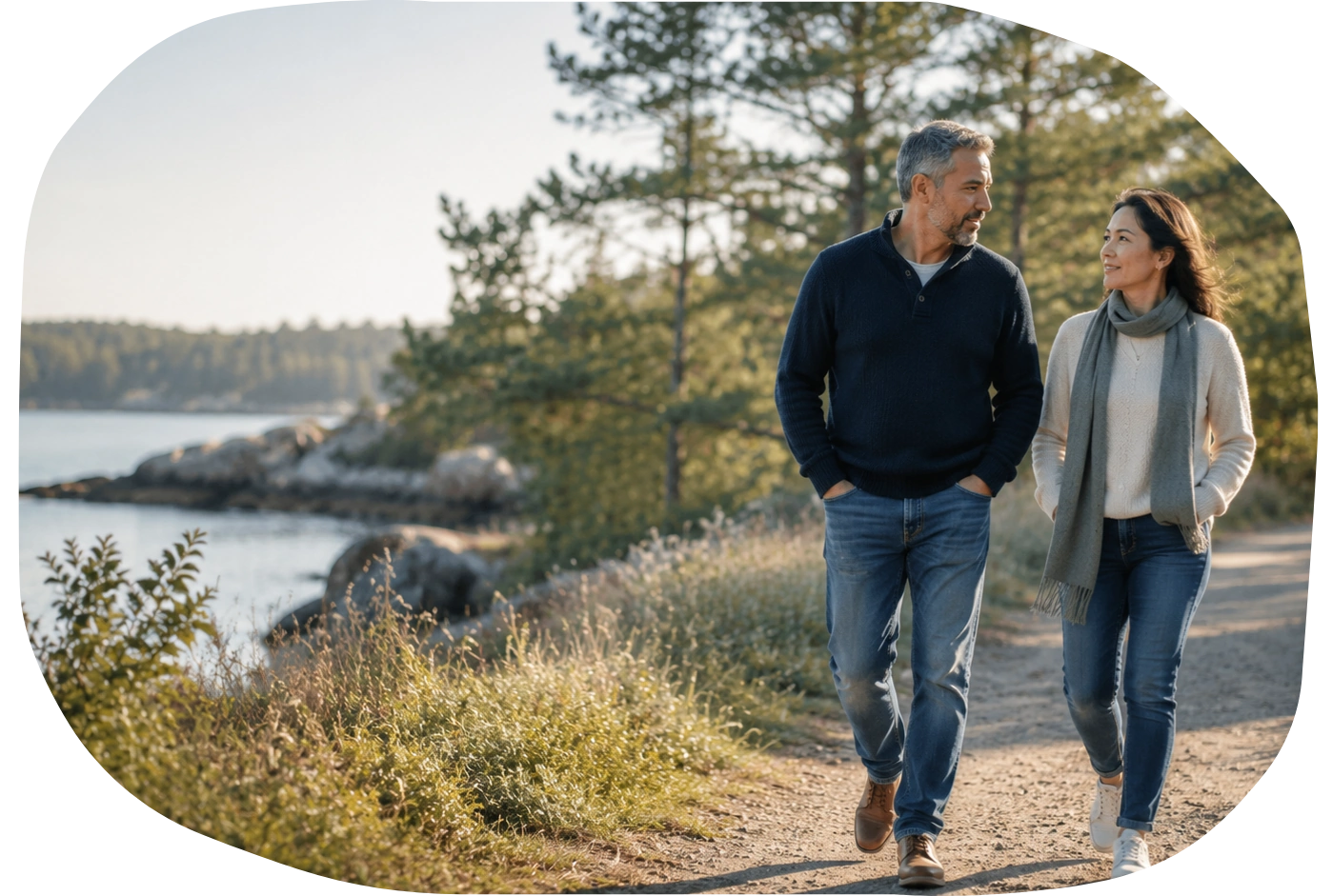 Companionship and stability over time A midlife couple walking peacefully together along a sunlit coastal path.